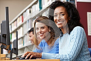 Students working on computers in library