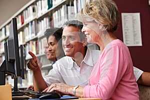 Students working on computers in library