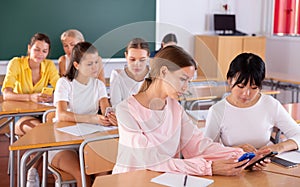 Students working in pairs using phones