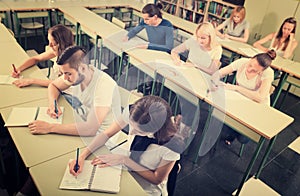 Students writing dictation in classroom