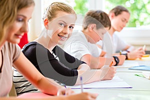 Students writing a test in school concentrating