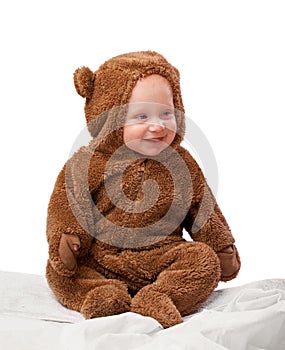 Studio, baby and onesie with costume, bear and toddler with joy and fun. Child, newborn and happiness with adorable