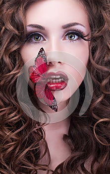 Studio beauty portrait with red butterfly