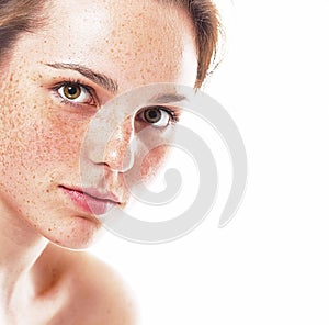 Studio beauty. Portrait of smiling young and happy woman with freckles. Isolated on white.