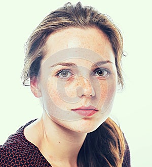 Studio beauty. Portrait of smiling young and happy woman with freckles. Isolated on white.