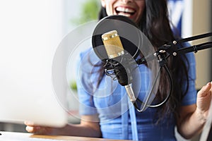 Studio black microphone in background woman sings closeup