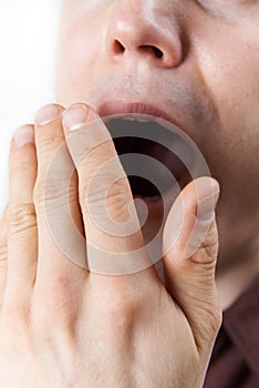 Studio Close Up Of Man Yawning