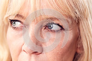 Studio Close Up Of Mature Woman Looking Suspicious And Distrustful