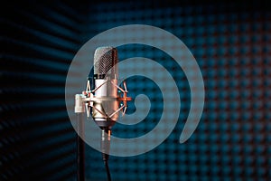 Studio condenser microphone on acoustic foam panel background