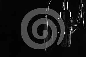 Studio condenser microphone isolated on black. Radio, vocals, podcasts. Copy space