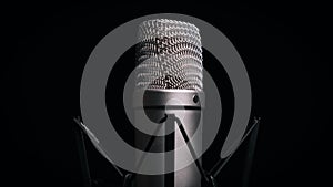 The Studio Condenser Microphone Rotates on a Black Background Close-Up