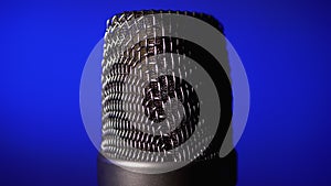 Studio condenser microphone rotates on blue background.