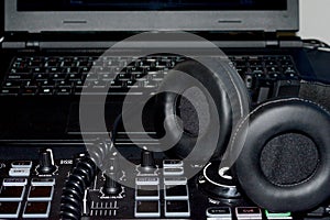 Studio DJ equipment glowing with light and pc