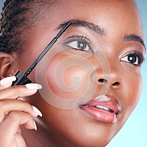 Studio face, black woman and eyebrow mascara, product or cosmetology tools for facial cosmetics application. Beauty photo