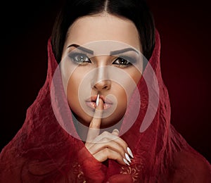 Studio, face, brown eyes, red shawl, finger near lips