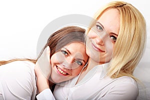 studio fashion image of two beautiful young women, isolated