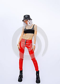 Studio Fashion Portrait Of Model Wearing red leather pants and trendy bucket hat. 90s clubbing street look book