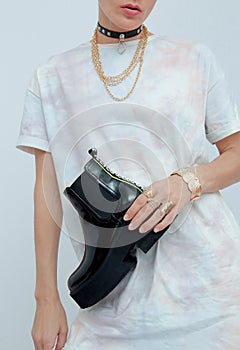 Studio Fashion Portrait Of Woman Wearing  casual White Clothes and stylish jewelry accessories. Trendy platform boots