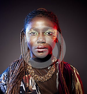 Studio fashion portrait of young African ethnicity woman with shiny make up