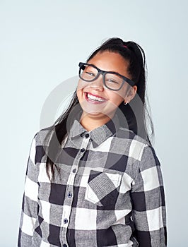 Studio, glasses and portrait of girl with smile for fashion, nerd style and quirky outfit. Female child, kid and eyewear