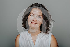 Studio head shot portrait of beautiful smiling brunette Caucasian middle aged woman