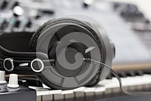 Studio headphones on the background of audio equipment