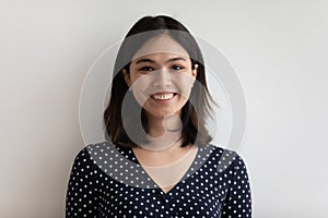 Studio headshot portrait of positive young female of asian ethnicity