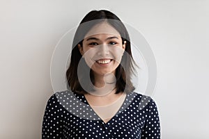 Studio headshot portrait of positive young female of asian ethnicity photo