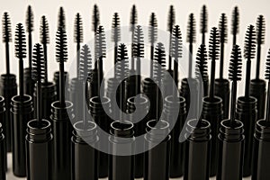Empty Mascara Tubes with Brushes on White Background