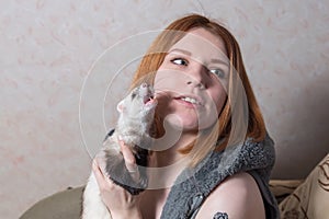 Studio image of a girl with a ferret