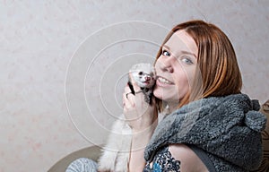 Studio image of a girl with a ferret