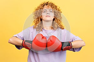 Rude woman in boxing gloves looking at camera