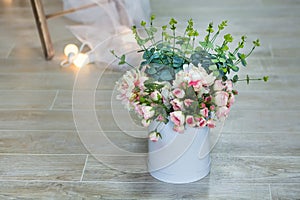 Studio interier decoration with flowers in light warm colors and casual vintage furniture