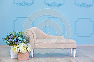 Studio interier decoration with flowers in light warm colors and casual vintage furniture