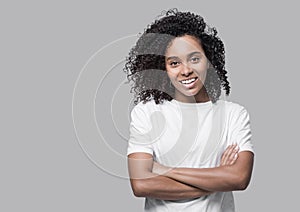 Studio isolated portrait of a beautiful young woman, African american girl with crossed arms looking at camera.