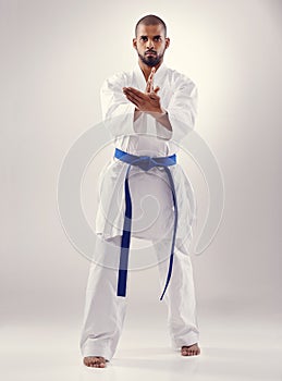 Studio, karate and black man training for power for physical health with fitness and effective technique. White