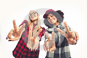 Studio lifestyle portrait of two best friends hipster girls going crazy and having great time together. Isolated on