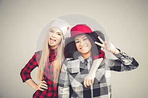 Studio lifestyle portrait of two best friends hipster girls going crazy and having great time together. on