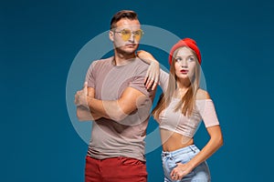 Studio lifestyle portrait of two best friends hipster wearing stylish bright outfits, hats, denim shorts and glasses