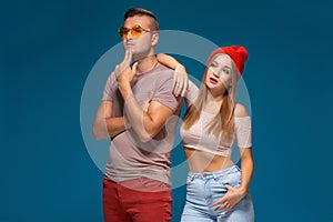 Studio lifestyle portrait of two best friends hipster wearing stylish bright outfits, hats, denim shorts and glasses