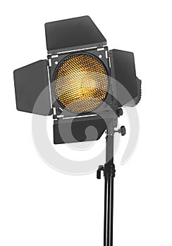 Studio lighting on a tripod stand, isolated on a white background. Spot light photography equipment.