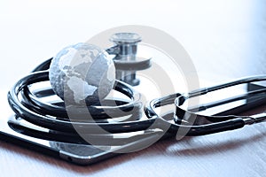 Studio macro of a stethoscope and texture globe