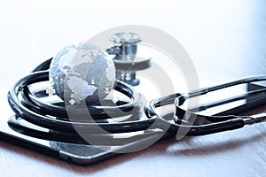 Studio macro of a stethoscope and texture globe