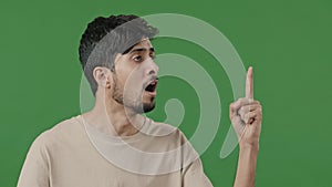 Studio male portrait on green background young thoughtful arabic guy creator thinking pondering plan searching for