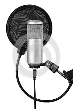 Studio microphone on the adjustable stand with a pop filter for an audio recording. Isolated on a white