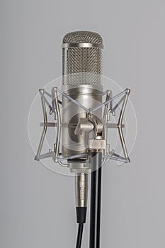 Studio microphone on a grey background. Condenser