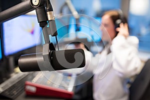 Studio Microphone in Radio Station with Female Host In Background