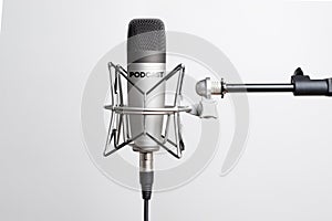 Studio microphone for recording podcasts, songs, and radio programs on a white background with a place for inscription photo