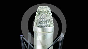 Studio Microphone with Spider Rotates on a Black Background