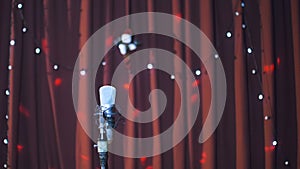 Studio microphone on a stage with lights on background